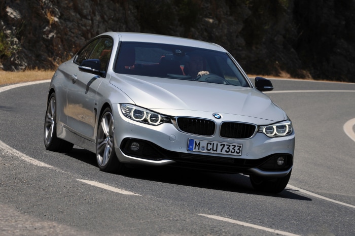 Silver BMW 435i Coupe Sport Line AT driving on a road