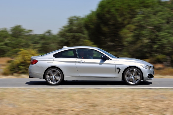 Silver BMW 435i Coupe Sport Line AT driving on road