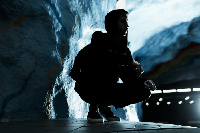 Alan Walker in a dark cave