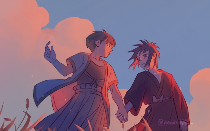 Two young men holding hands at sunset