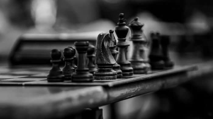 Black and White Chess Pieces on Board