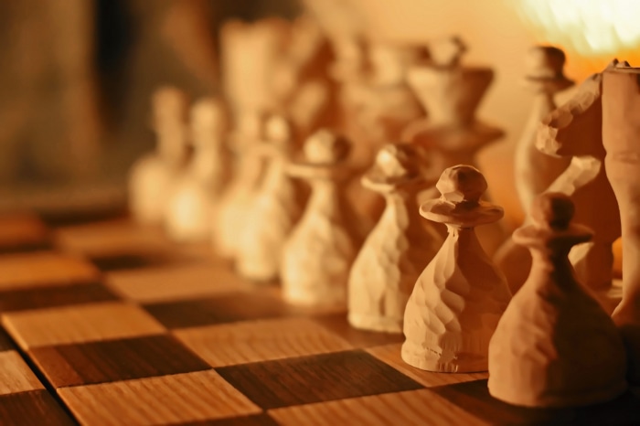 Wooden Chess Pieces on Chessboard