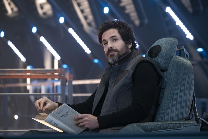 Cristobal Chris Rios from Star Trek: Picard reading a book