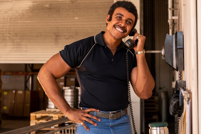 Dwayne Johnson as a young man on the phone
