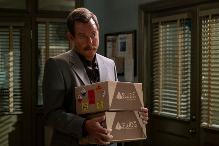 Terry Seattle from Murderville holding boxes