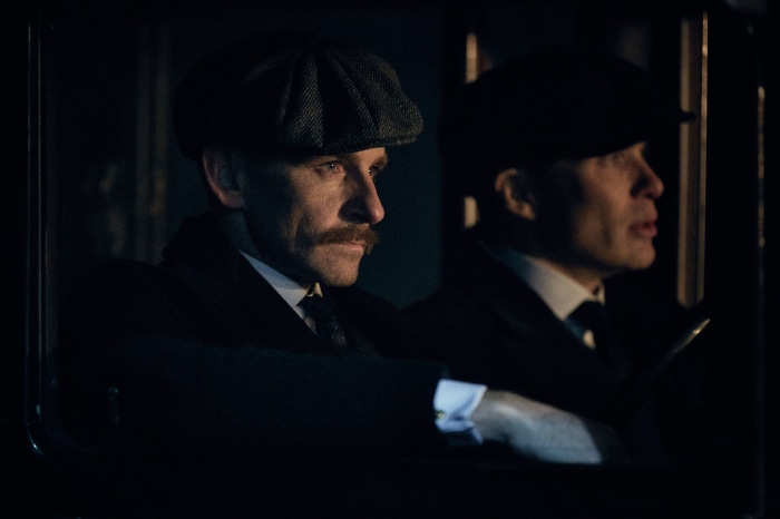 Two men in hats in a car