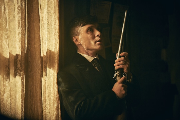 Thomas Shelby from Peaky Blinders holding a rifle