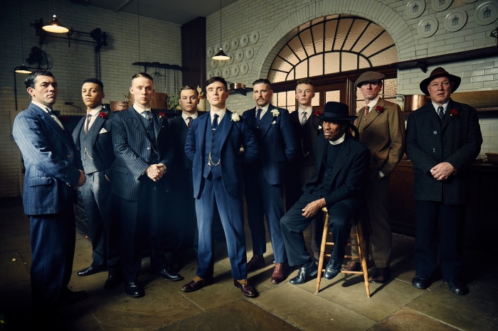 Peaky Blinders cast posing in a room