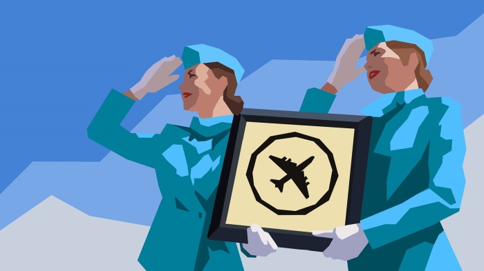 Two flight attendants holding an airplane sign