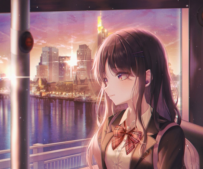 Girl looking out a window at a city skyline at sunset