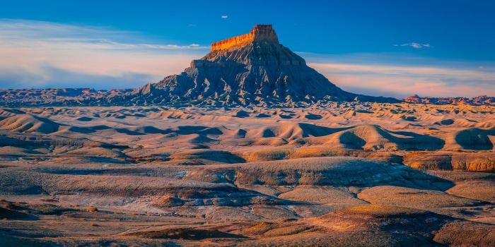 Desert landscape with a large mesa at sunrise