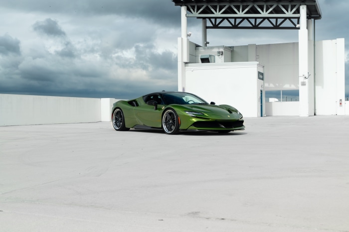 Green Ferrari SF90 Stradale parked on rooftop