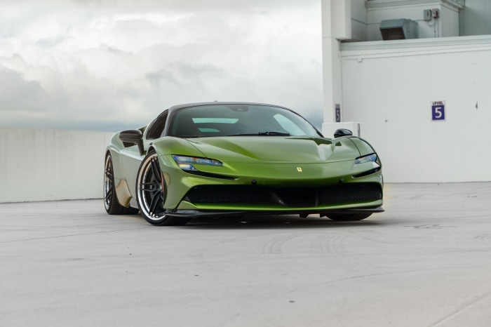 Green Ferrari SF90 Stradale parked on a rooftop