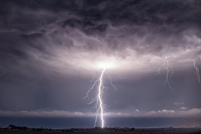 Lightning strikes during a thunderstorm over a field