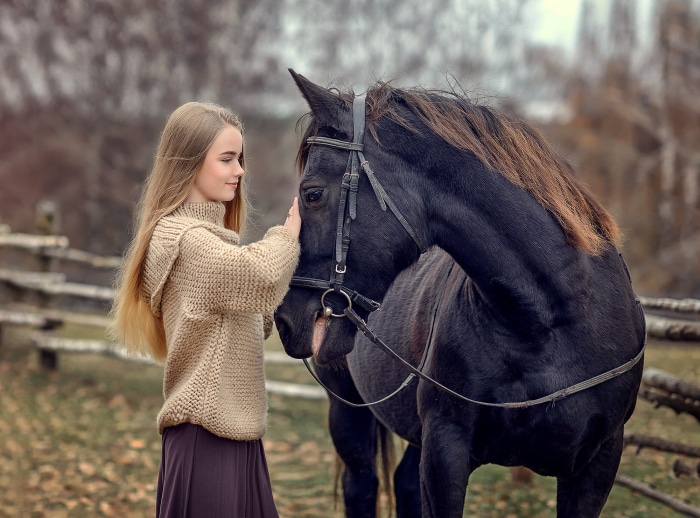Young girl with a black horse