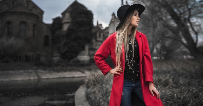 Woman in red coat and hat near castle