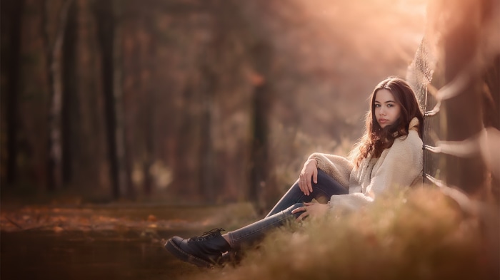 Young woman sitting in a forest