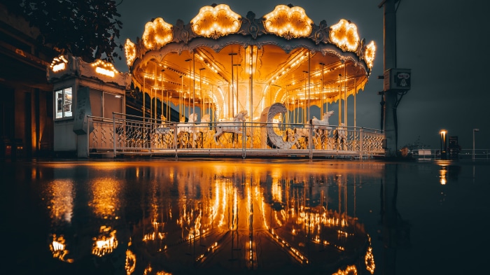 Carousel with illuminated horses at night
