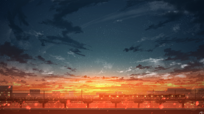 Train on elevated tracks at sunset with city skyline