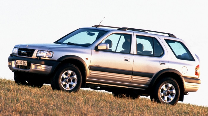 Silver Opel Frontera SUV parked on a grassy hill