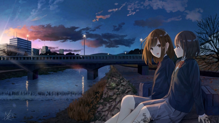 Two girls in school uniforms by a river at dusk