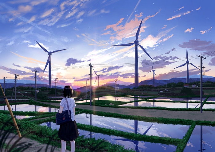 Girl watching sunset with wind turbines