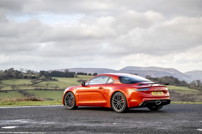 Orange Alpine A110S sports car on a road