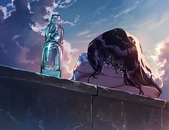 Girl crying next to a bottle