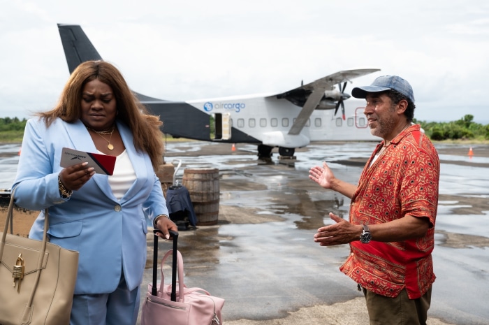 DaVine Joy Randolph and Oscar Nuñez on tarmac with airplane