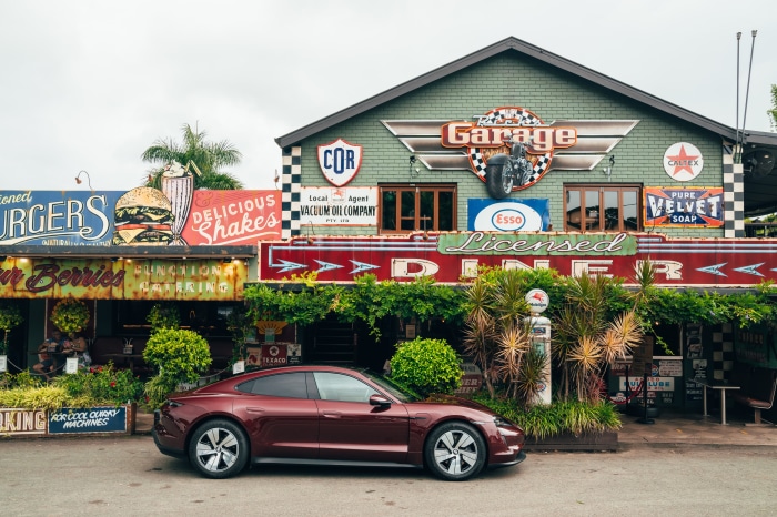 Porsche Taycan 4K in front of a retro diner