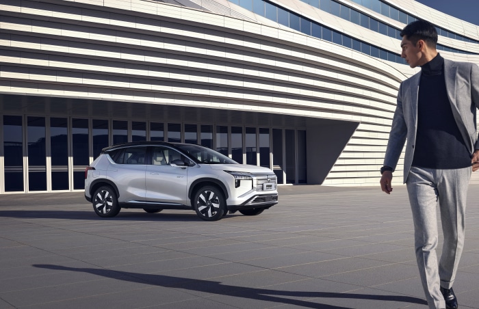 Mitsubishi Airtrek electric SUV and businessman