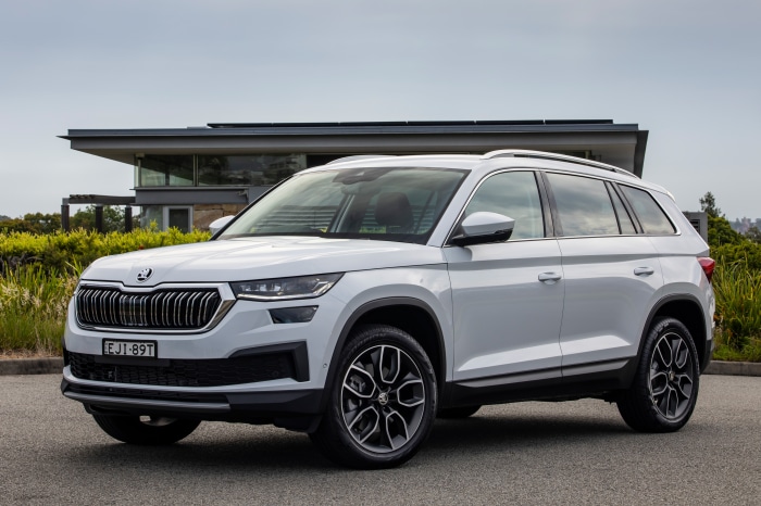 White Skoda Kodiaq SUV parked in front of a modern house