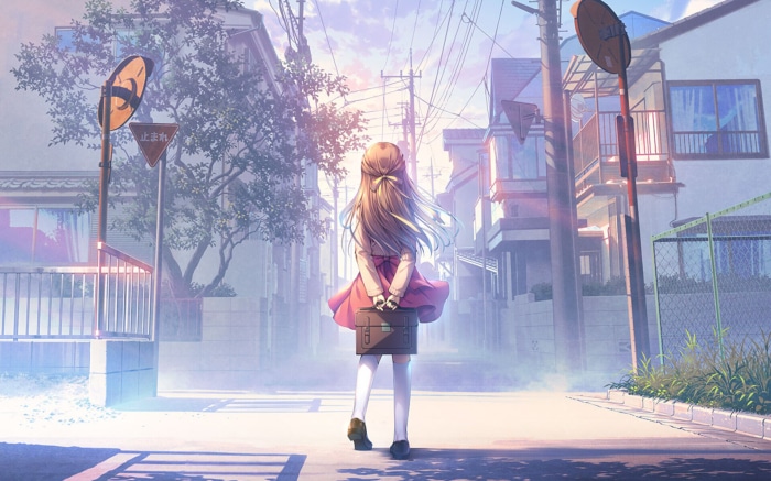 Girl with suitcase walking down a suburban street