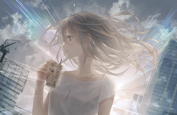 Girl holding a coffee cup in a city