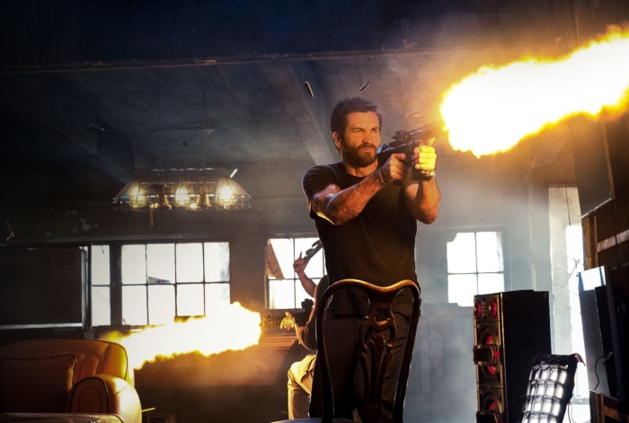 Jake Gyllenhaal firing a gun