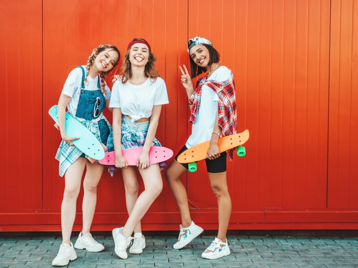 Three young women with skateboards