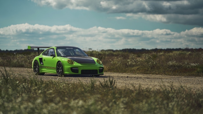 Green Porsche 911 GT2 on a dirt road