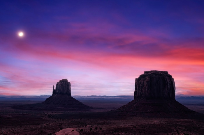 Monument Valley desert sunset with moon