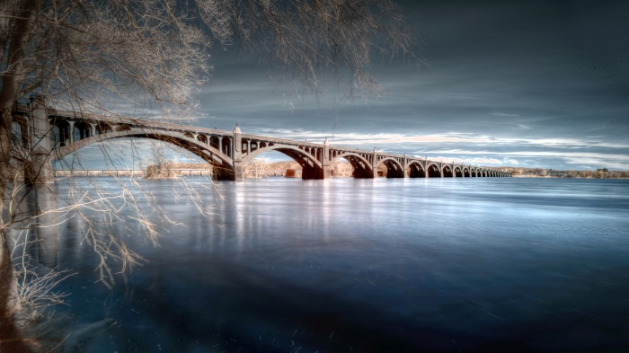 Long arched bridge over water 4K