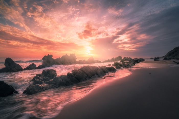 Beach Sunrise with Rocks and Ocean Waves