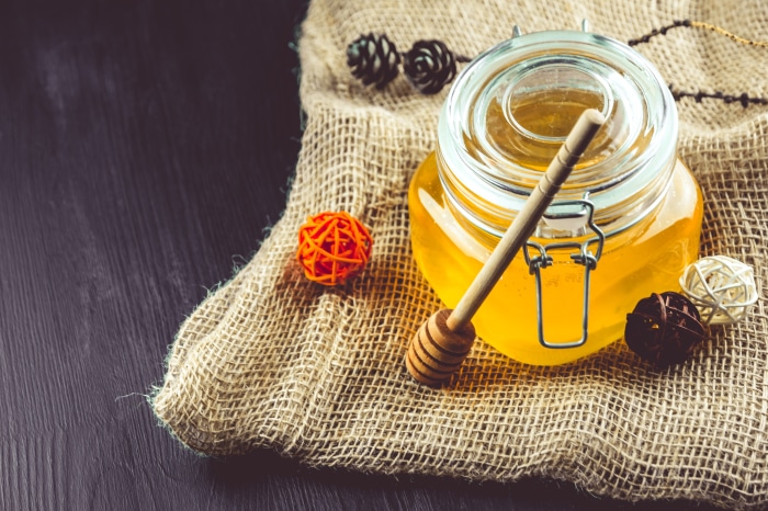 Jar of Honey with Dipper on Burlap