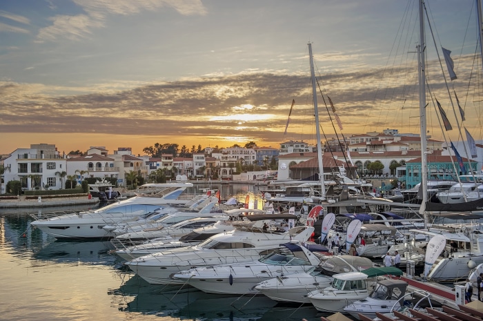 Yachts in harbor at sunset