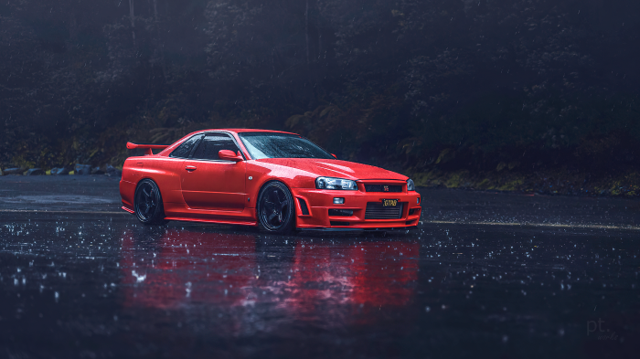 Red Nissan Skyline R34 GT-R in the rain