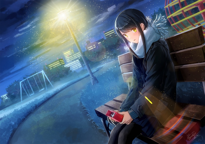 Girl sitting on a bench at night