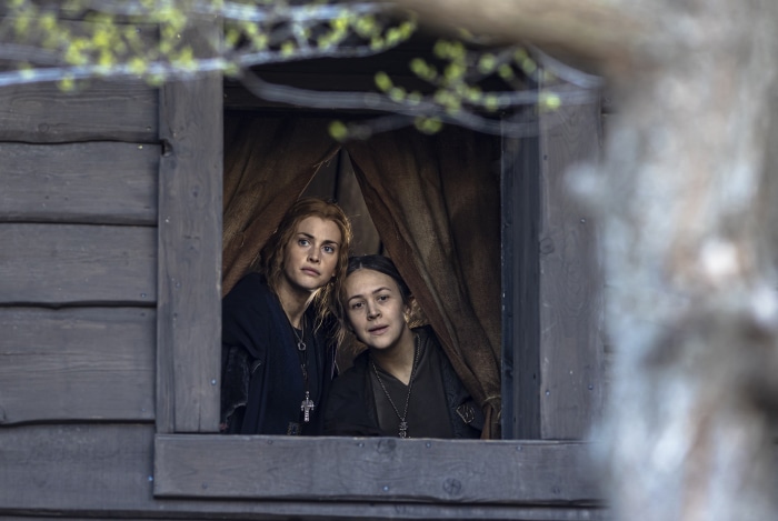 Two women looking out of a wooden window in The Last Kingdom 4K