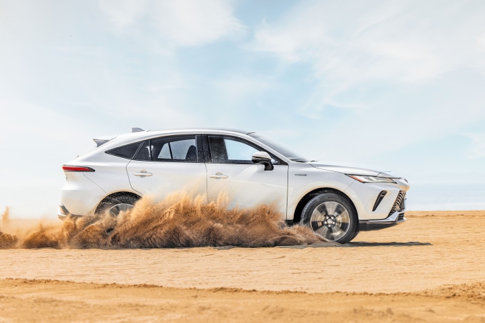 White Toyota Venza Hybrid driving on sand