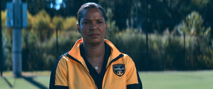Woman in yellow jacket with Wild logo