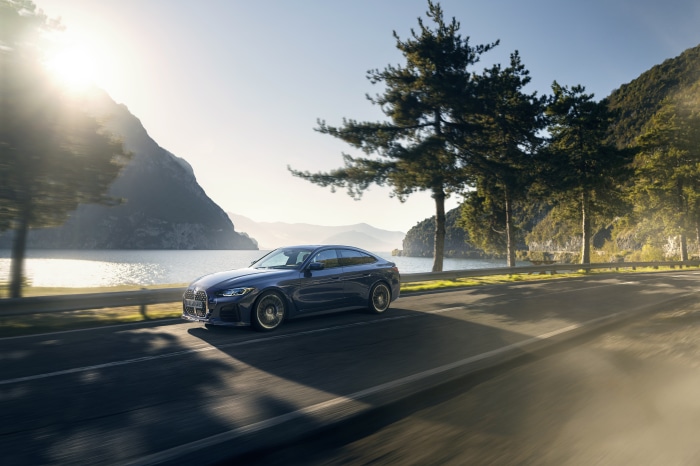 Alpina B4 Gran Coupé driving by a lake