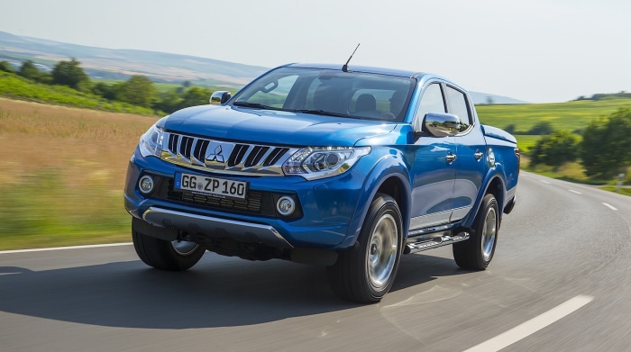 Blue Mitsubishi L200 HD pickup truck driving on a road