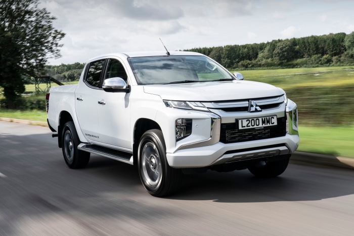 White Mitsubishi L200 MMC Pickup Truck Driving on Road